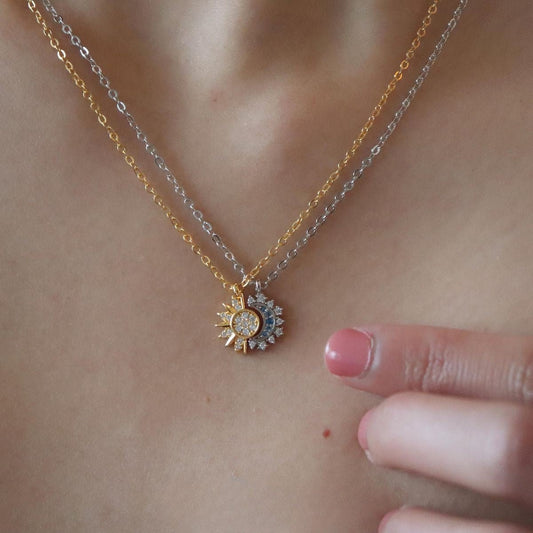 Necklace with a sun-shaped pendant on a person's neck