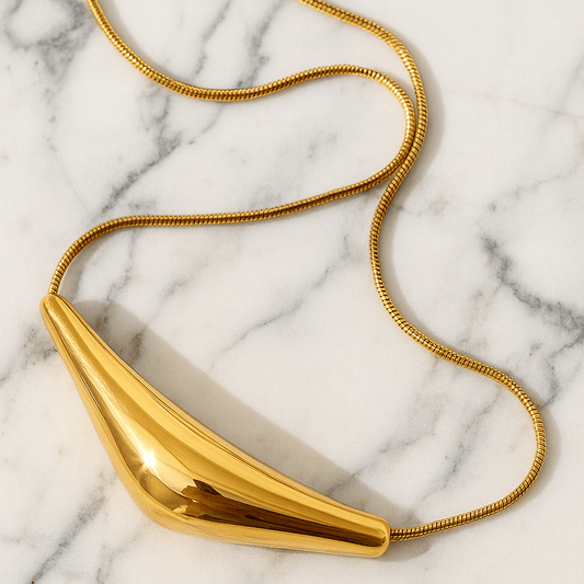 Gold necklace on a marble surface