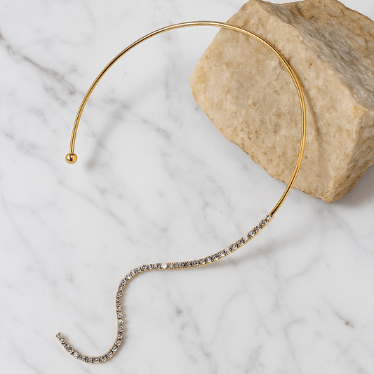 Gold headband with small beads on a marble surface