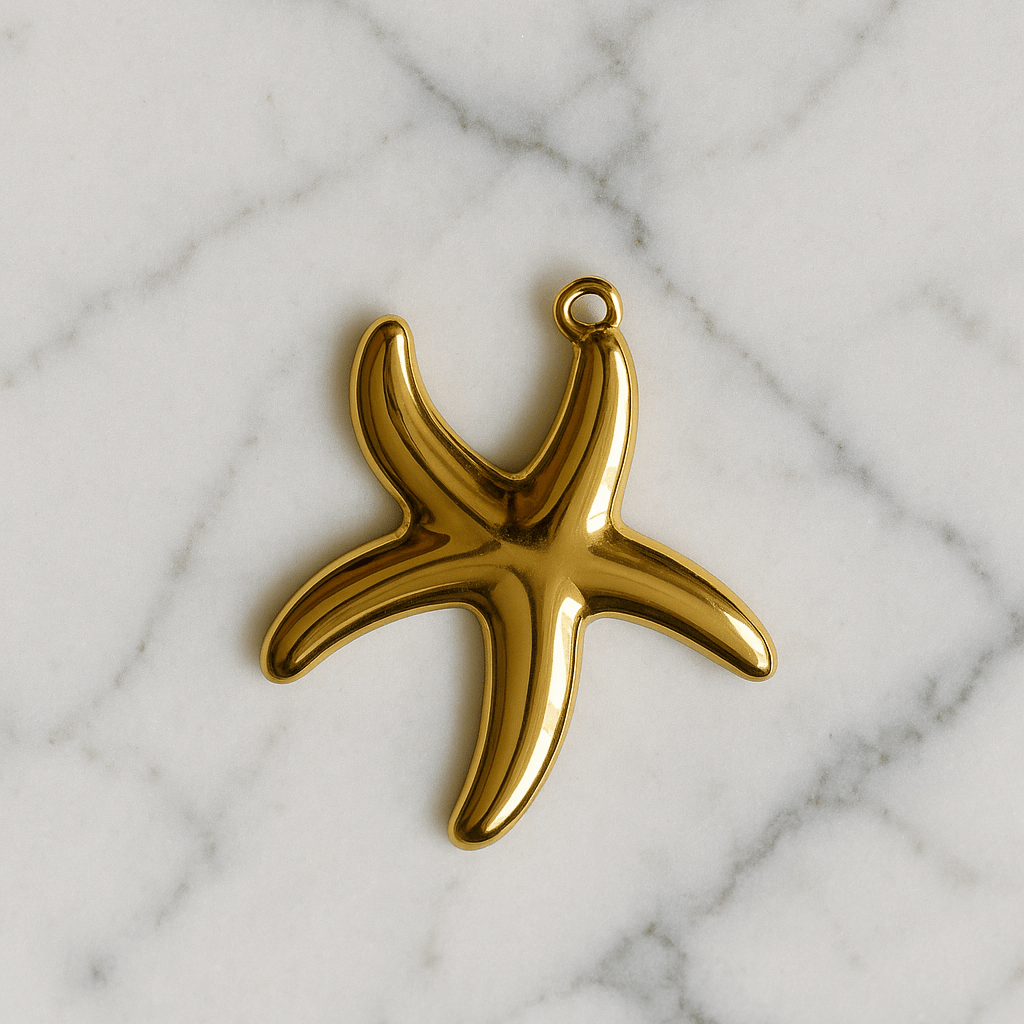 Gold starfish-shaped pendant on a marble background