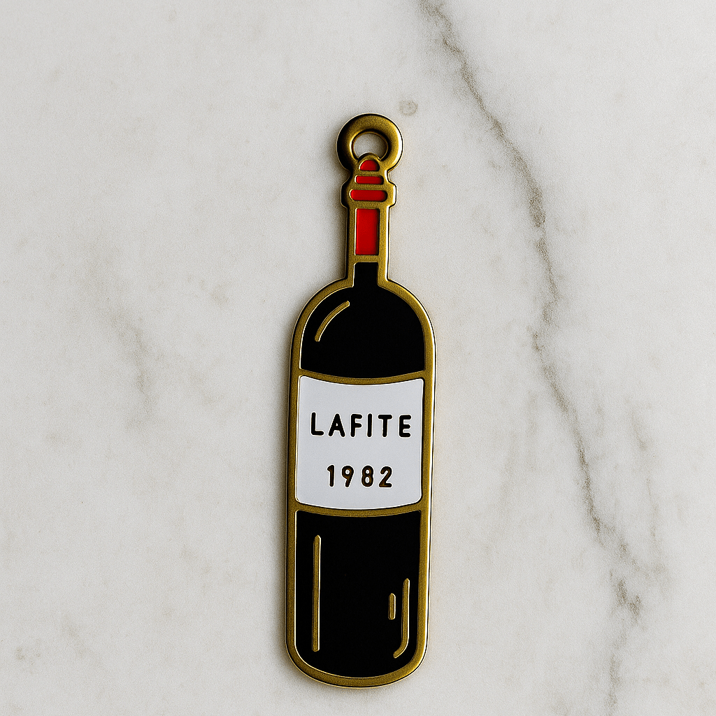 Enamel pin of a wine bottle labeled 'Lafite 1982' on a marble background