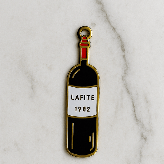 Enamel pin of a wine bottle labeled 'Lafite 1982' on a marble background
