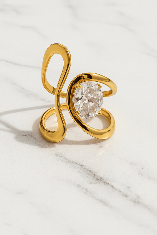 Gold ring with a large diamond on a marble surface