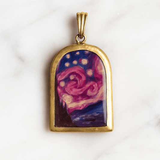 Gold pendant with a colorful abstract design on a white marble background
