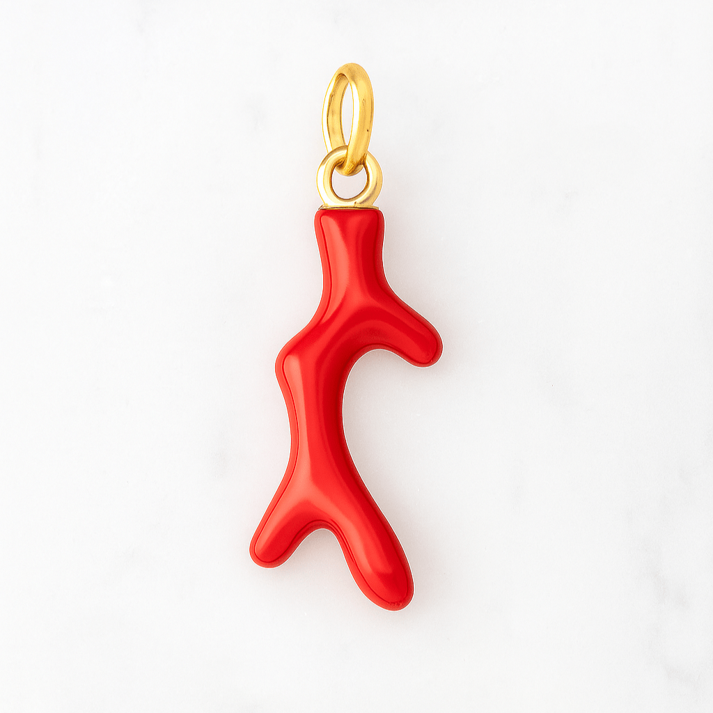 Red coral pendant with gold chain on a white background