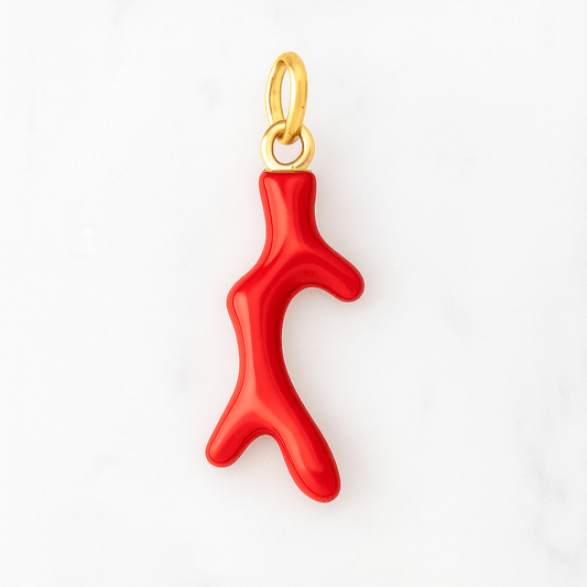 Red coral pendant with gold chain on a white background