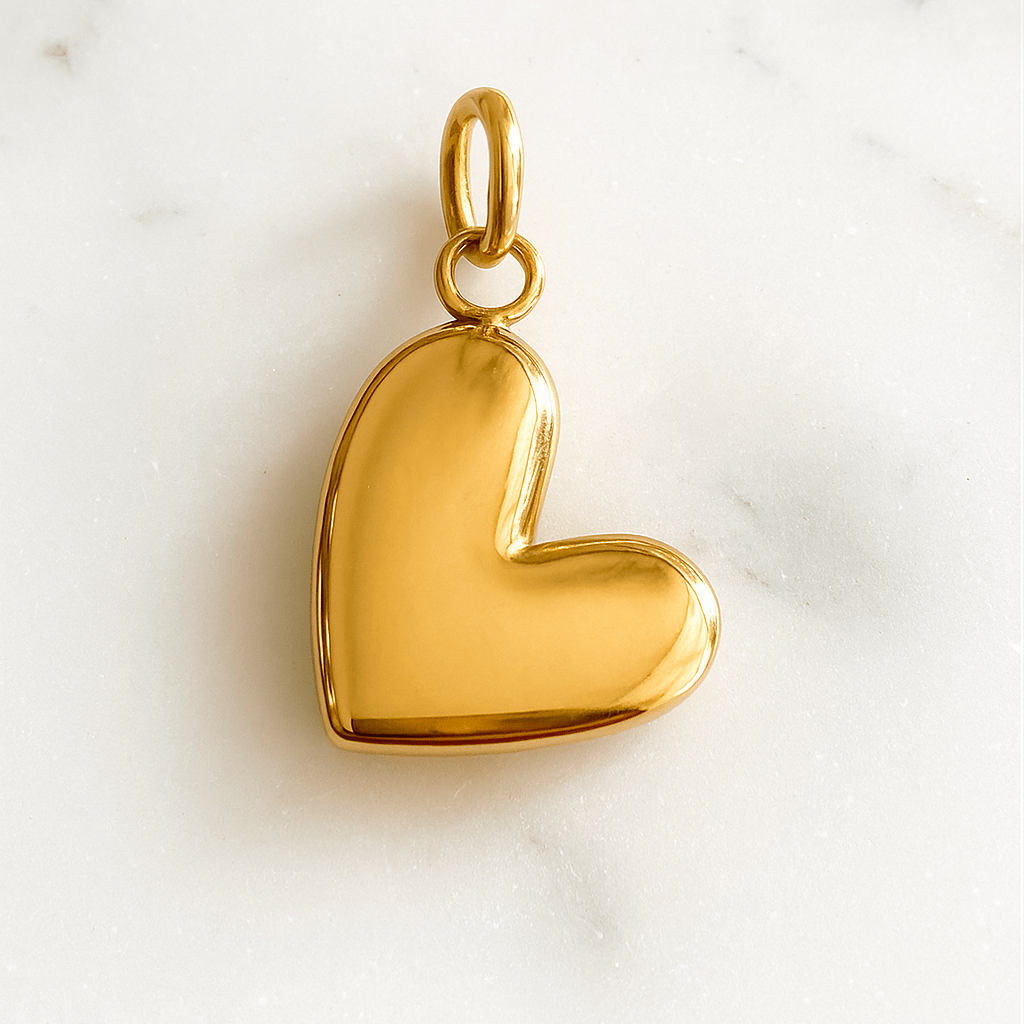 Gold heart-shaped pendant on a marble background
