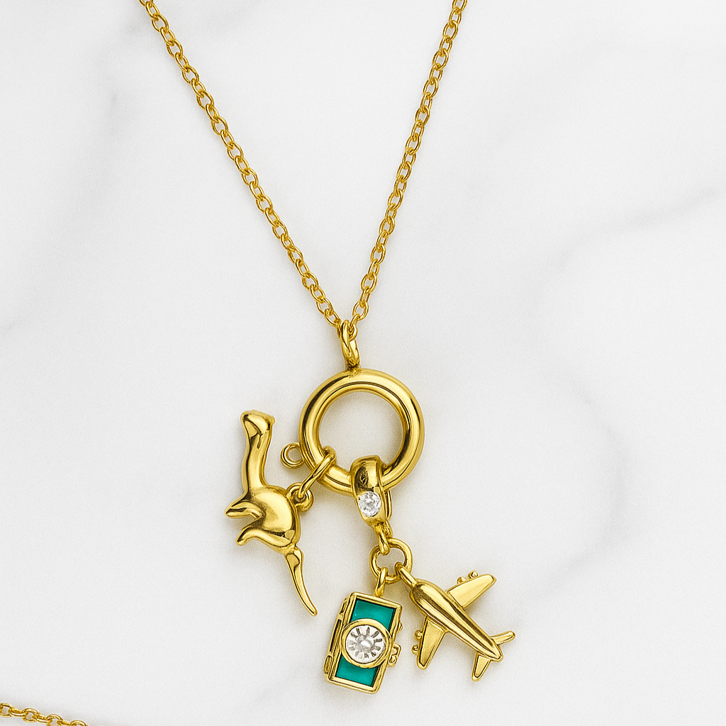Gold necklace with travel-themed charms on a white background