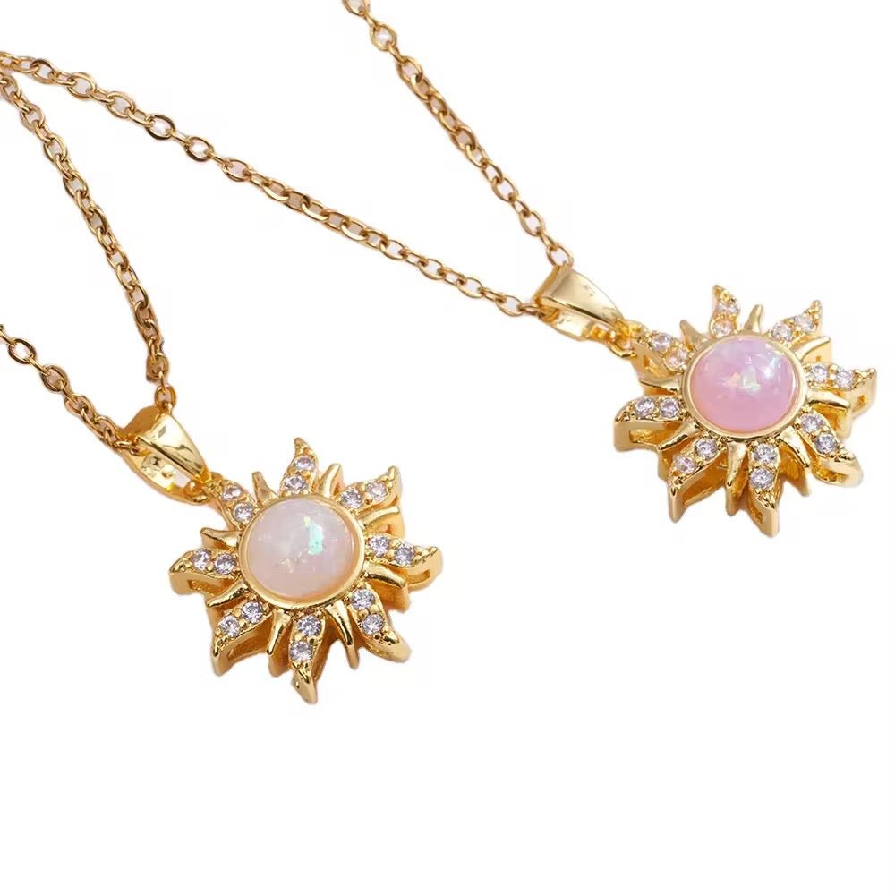 Gold necklaces with pink gemstone pendants on a white background