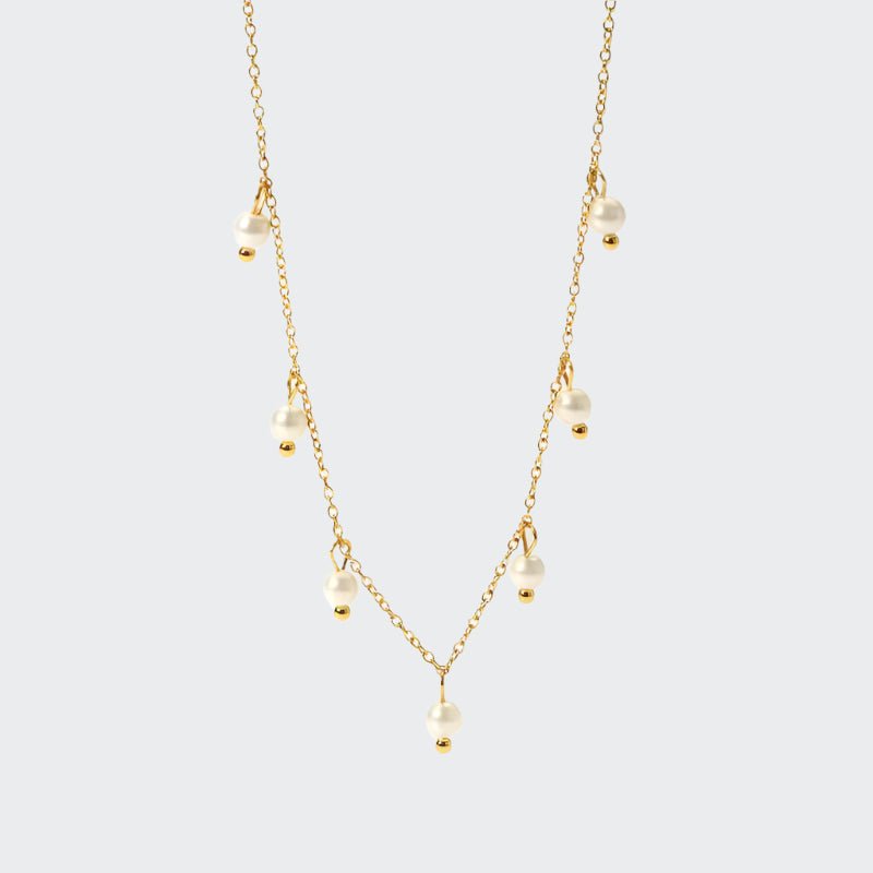 A delicate gold chain necklace adorned with luminous freshwater pearls.