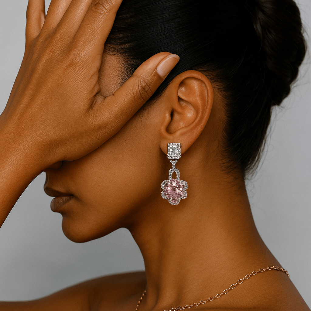 Close-up of a woman wearing a pink gemstone earring with a neutral background