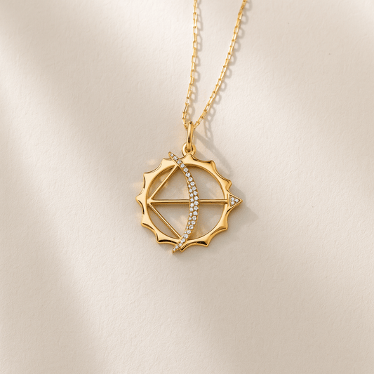 Gold necklace with a decorative pendant on a beige background