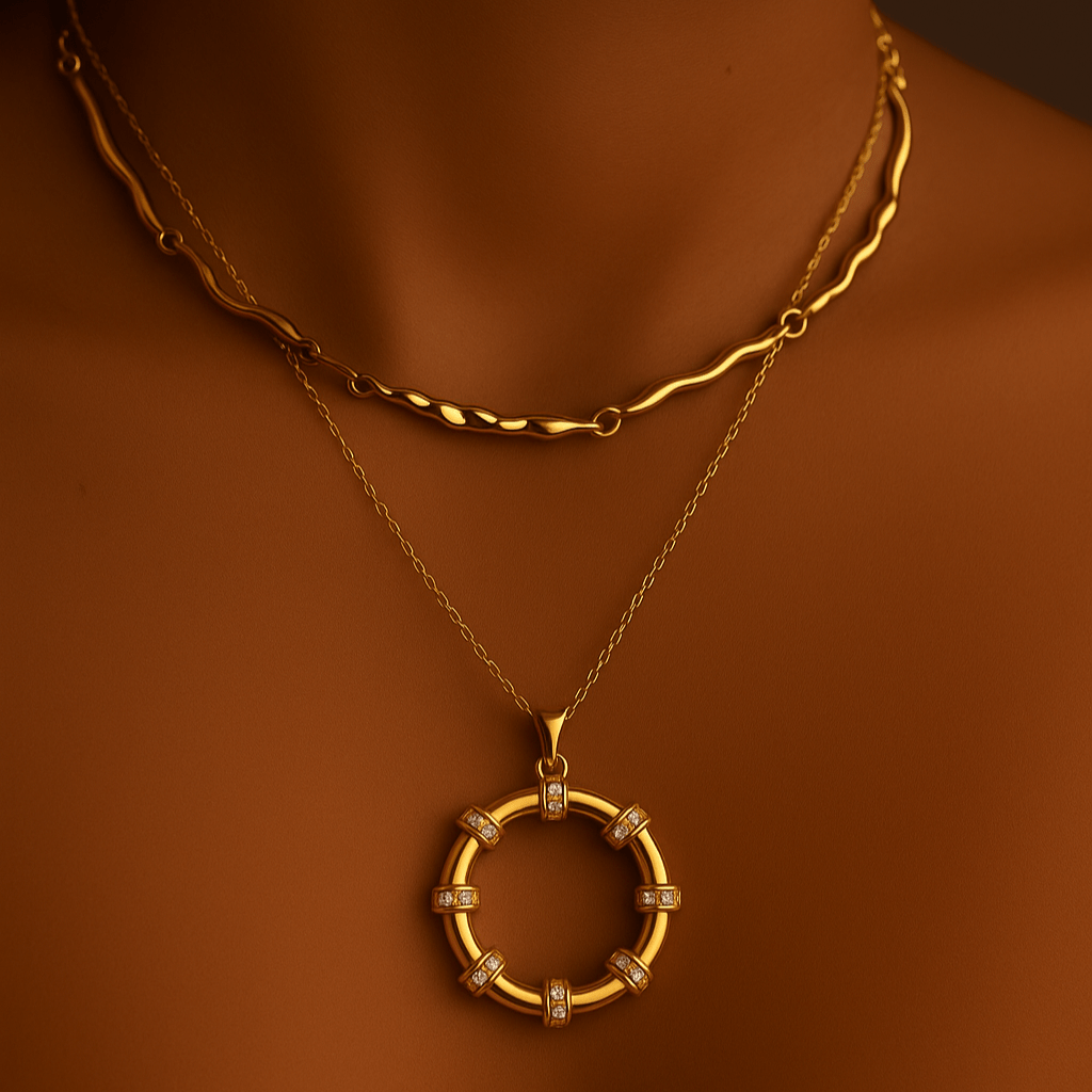 Gold necklace with a circular pendant on a person against a dark background