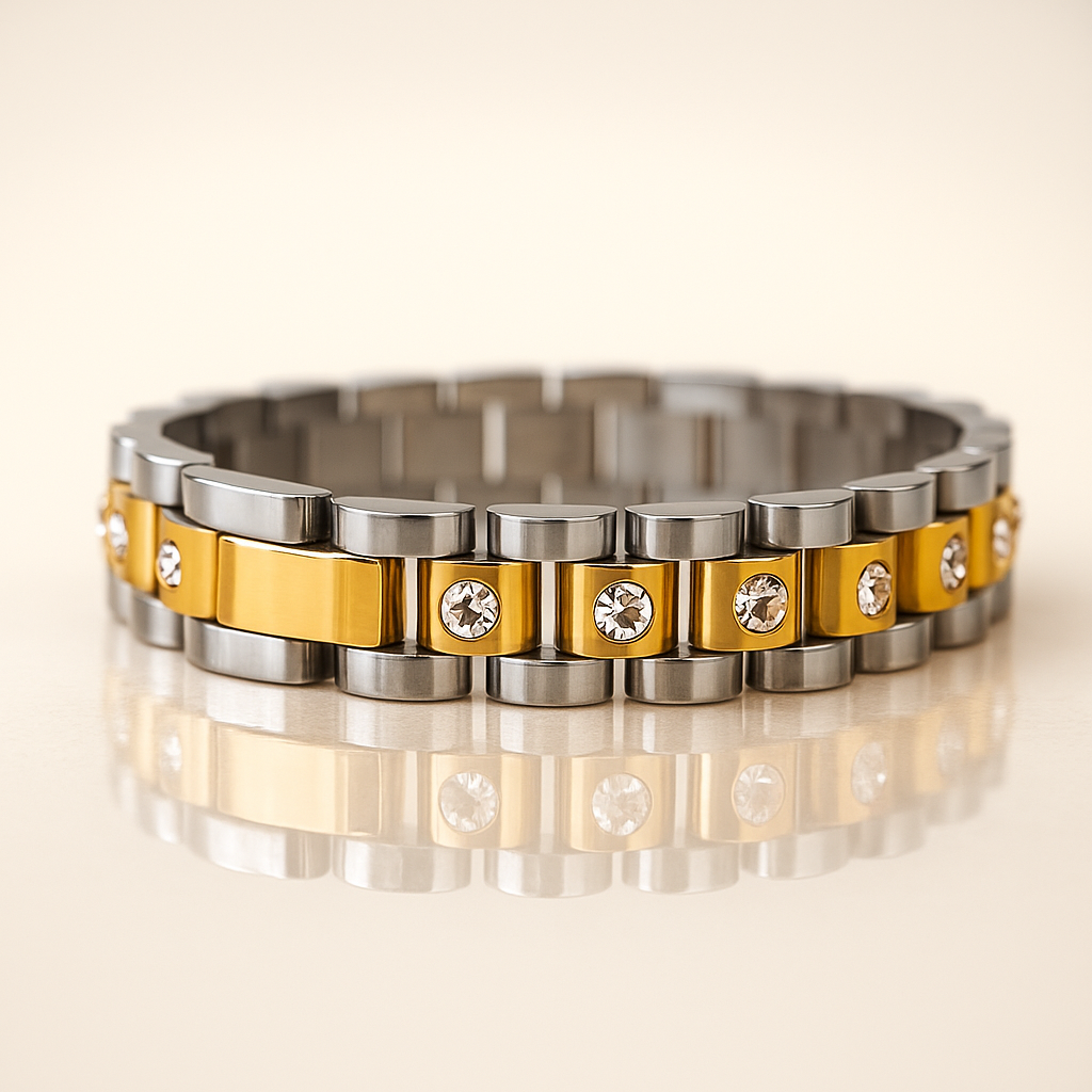 Bracelet with alternating gold and silver segments on a reflective surface