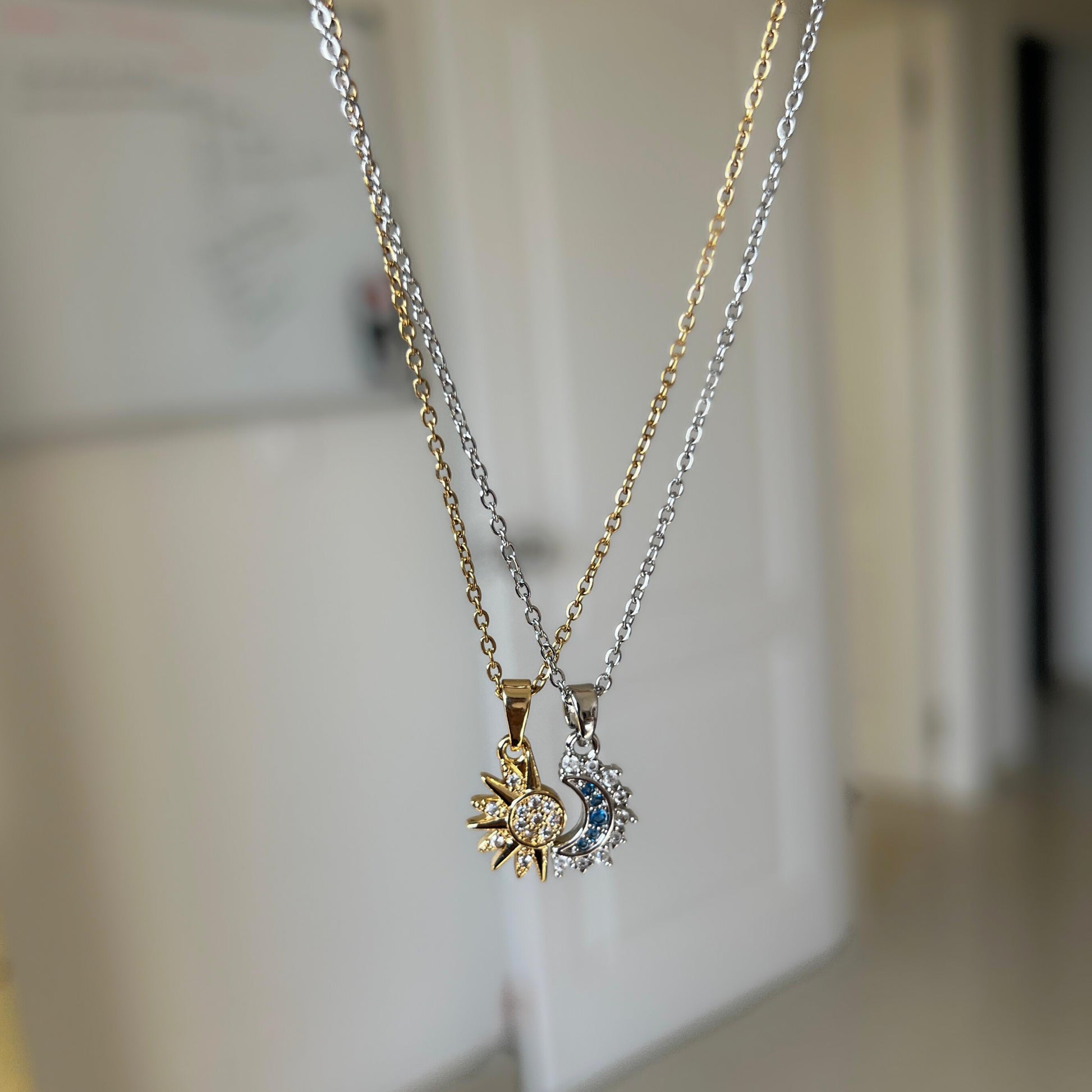 Two necklaces with pendants on a blurred background
