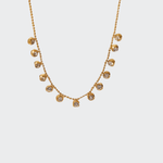 A golden chain necklace adorned with a series of crystal pendants in an alternating pattern.