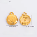 Two gold pendants with zodiac designs on a light gray background