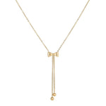 A gold-colored bow necklace with a chain link design and a small spherical pendant at the end.