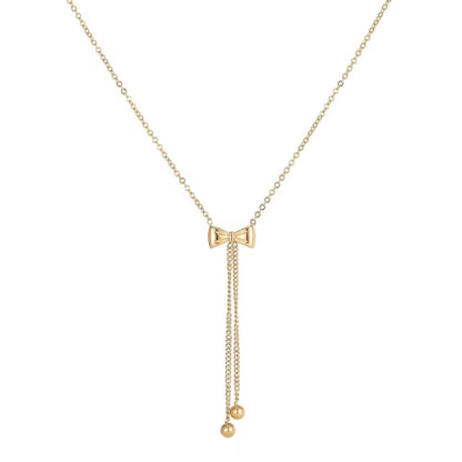 A gold-colored bow necklace with a chain link design and a small spherical pendant at the end.