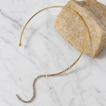 Gold headband with small beads on a marble surface