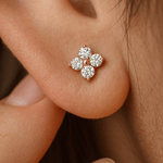 Close-up of a diamond earring on an ear with a blurred background