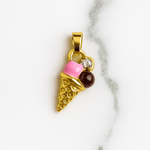 Gold ice cream cone pendant with pink cherry and brown chocolate on a marble background