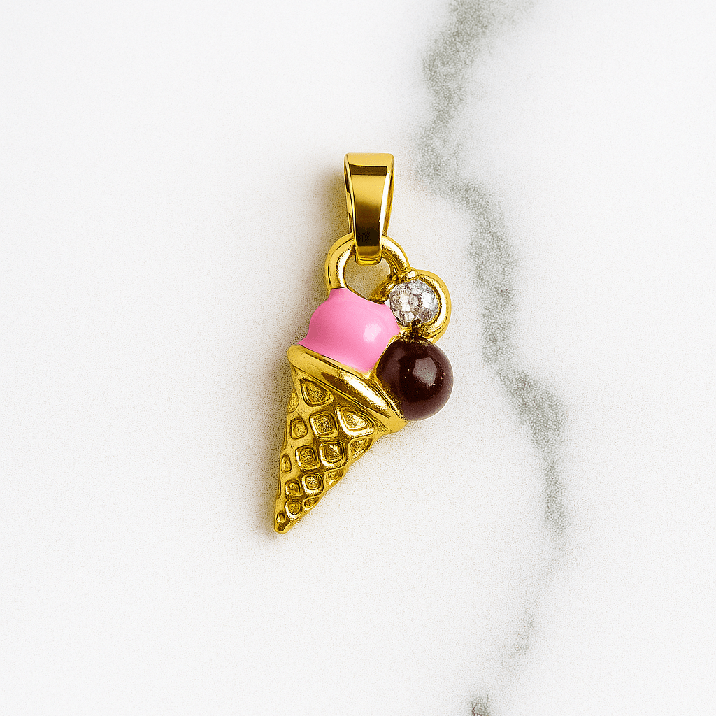 Gold ice cream cone pendant with pink cherry and brown chocolate on a marble background