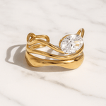 Gold ring with a large diamond on a light background