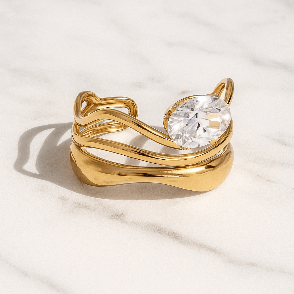 Gold ring with a large diamond on a light background