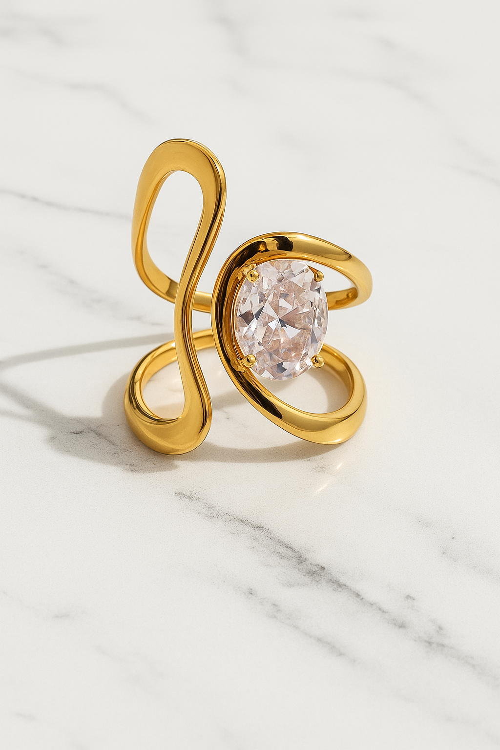 Gold ring with a large diamond on a marble surface