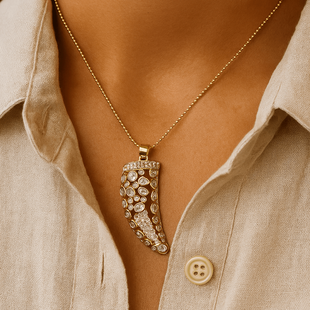Necklace with a decorative pendant worn by a person wearing a beige shirt.