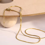 Gold necklace on a wooden surface