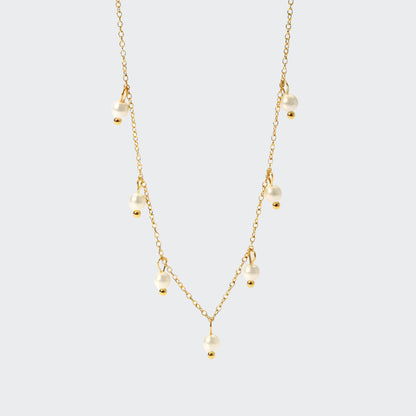 A delicate gold chain necklace adorned with luminous freshwater pearls.