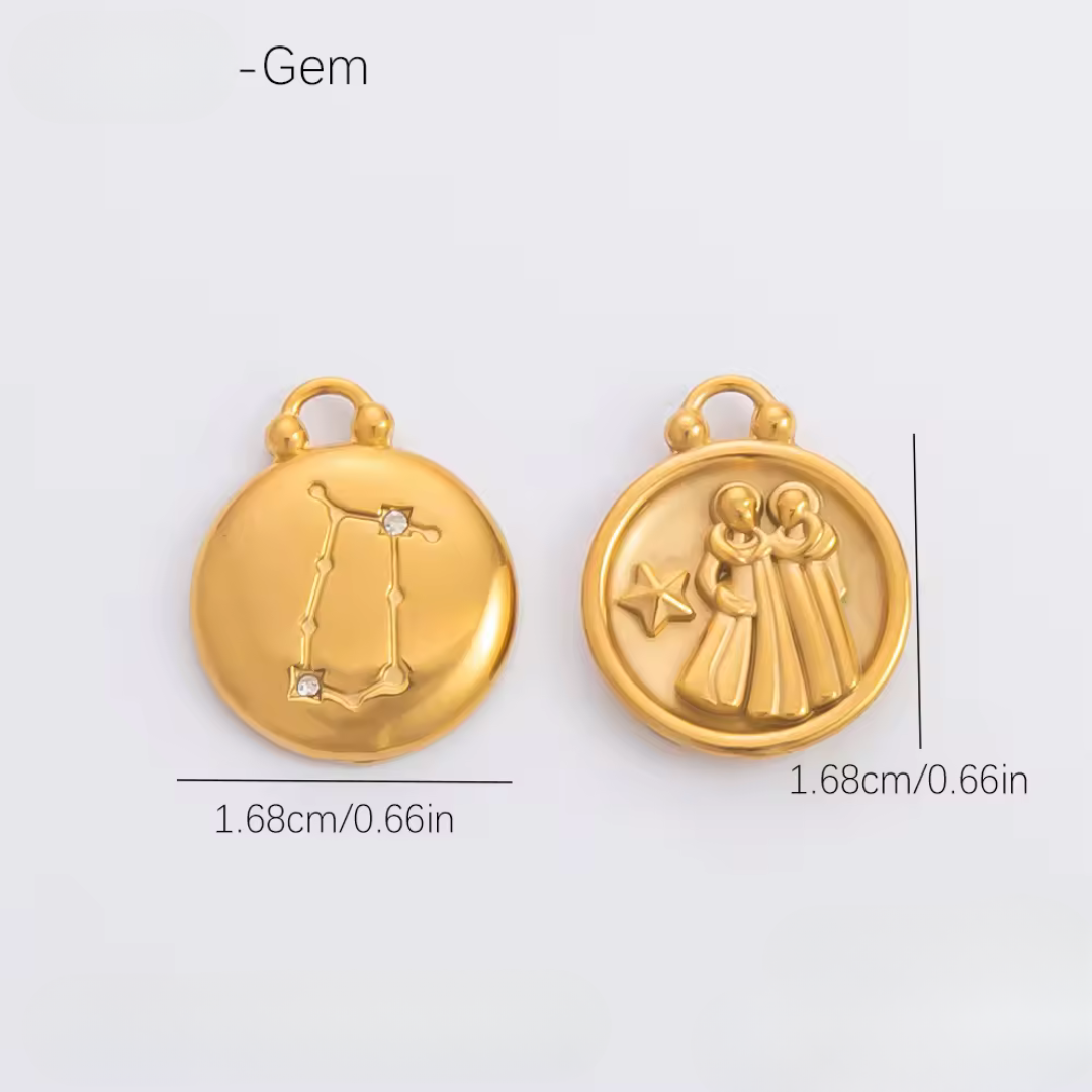 Two gold pendants with measurements on a light gray background