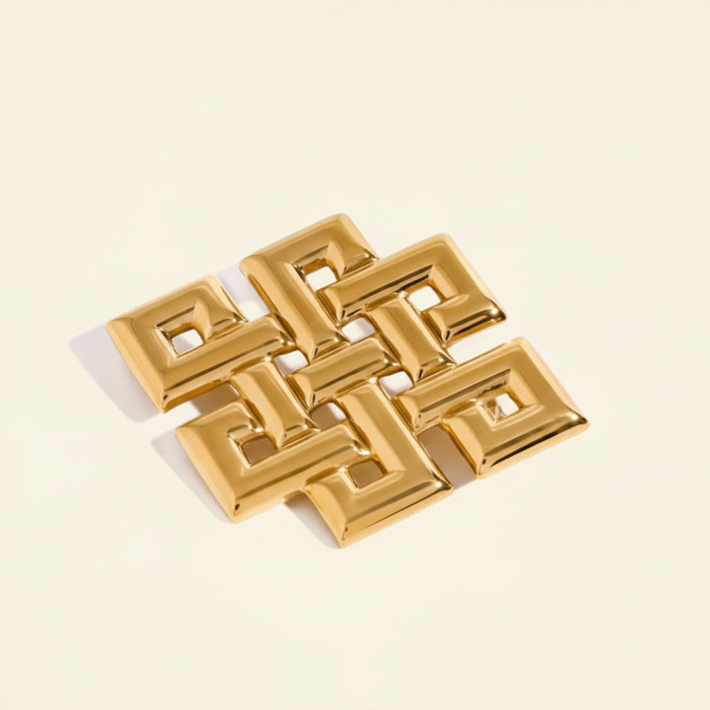 Gold geometric pendant with measurements on a white background