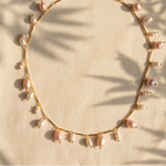 A delicate gold chain necklace adorned with small pearls and larger baroque-style pearls in soft pink and white tones, 18k Gold plated on stainless steel
