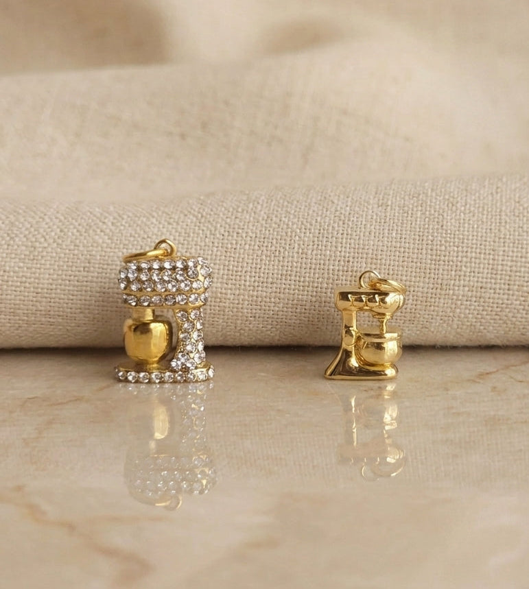 Gold earrings with gemstones on a beige fabric background