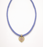 Necklace with blue beads and a heart-shaped pendant on a white background
