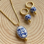 Jewelry set with necklace and earrings on a wooden surface