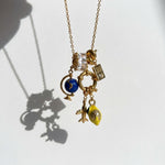 Necklace with various charms on a white background