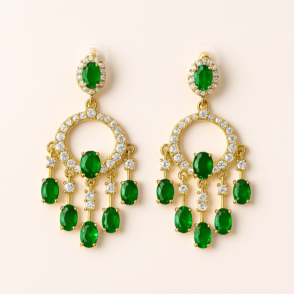 Gold earrings with green gemstones on a beige background