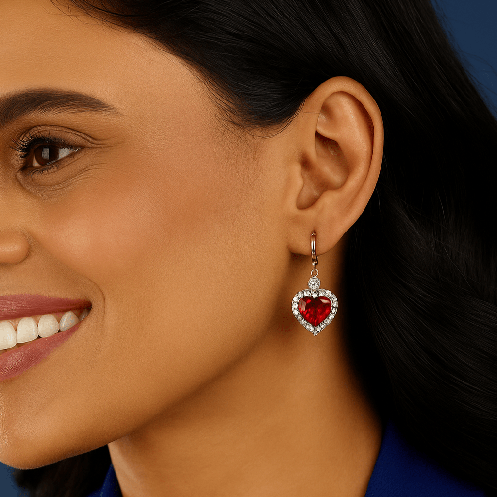 Close-up of a woman wearing a heart-shaped earring with a blue background
