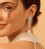 Close-up of a woman wearing a sparkling earring against a beige background