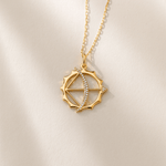 Gold necklace with a decorative pendant on a beige background