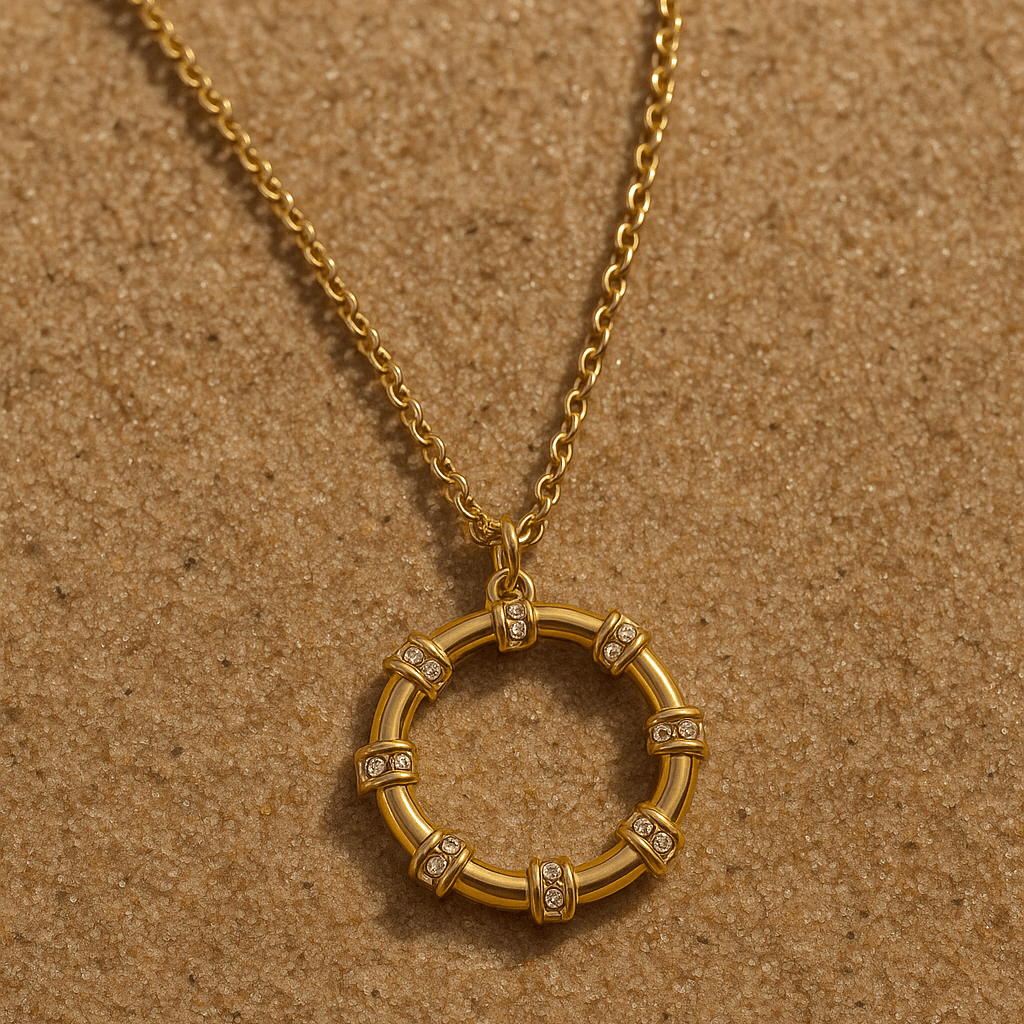 Gold necklace with a circular pendant on a brown textured background