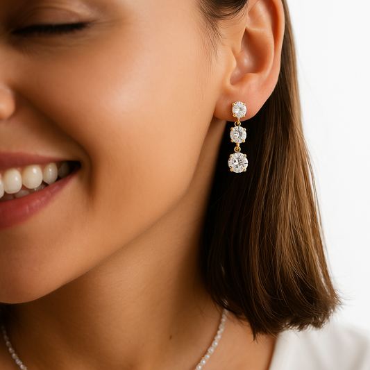 Close-up of a woman wearing diamond earrings with a blurred background