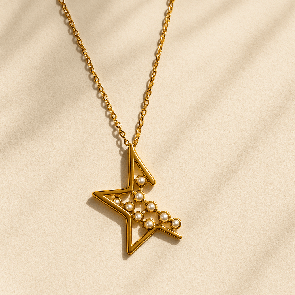 Gold necklace with a star-shaped pendant on a beige background