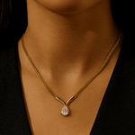 Gold necklace with a diamond pendant on a dark background