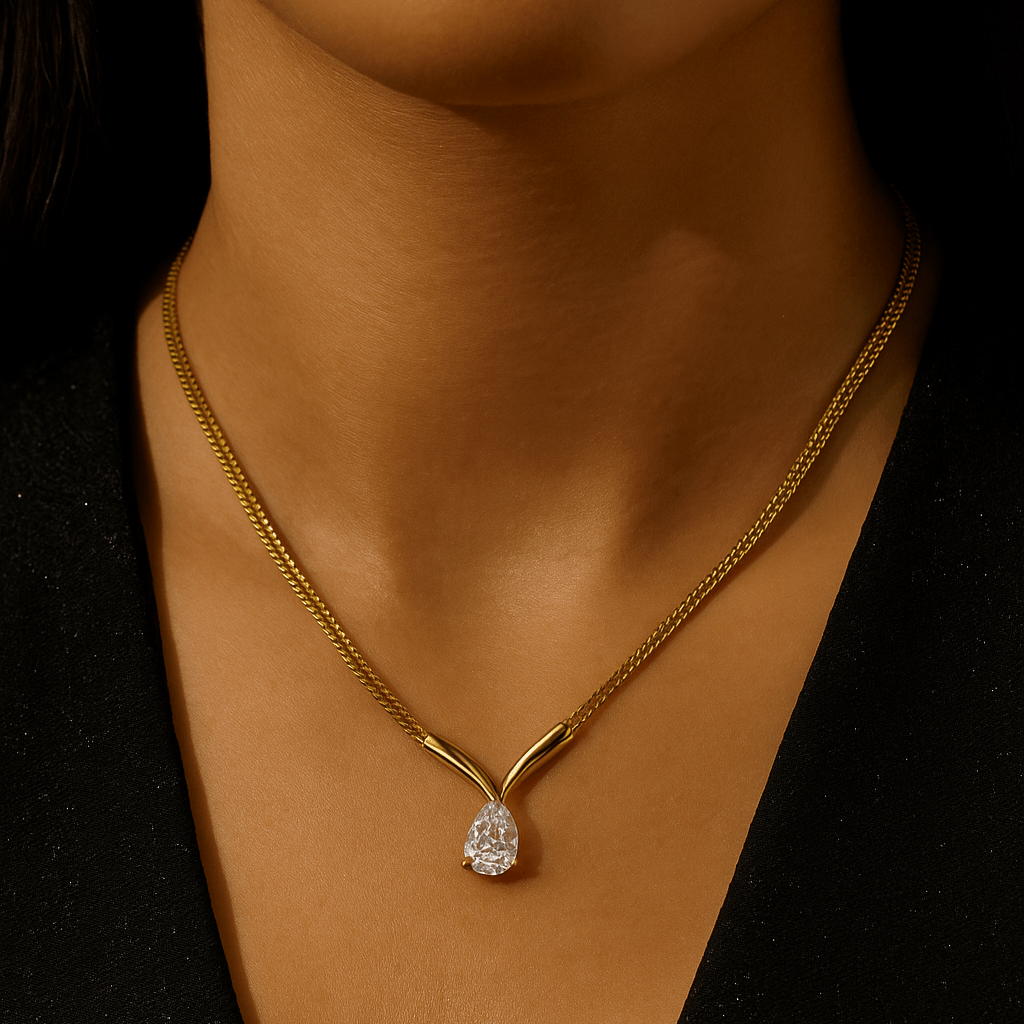 Gold necklace with a diamond pendant on a dark background