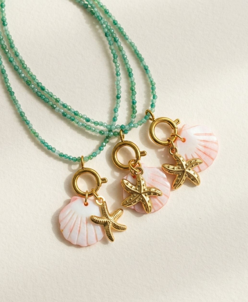 Necklace with shell and starfish charms on a light background